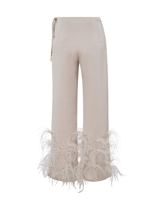 Satin champagne high waisted pants with scattered feathers. Back