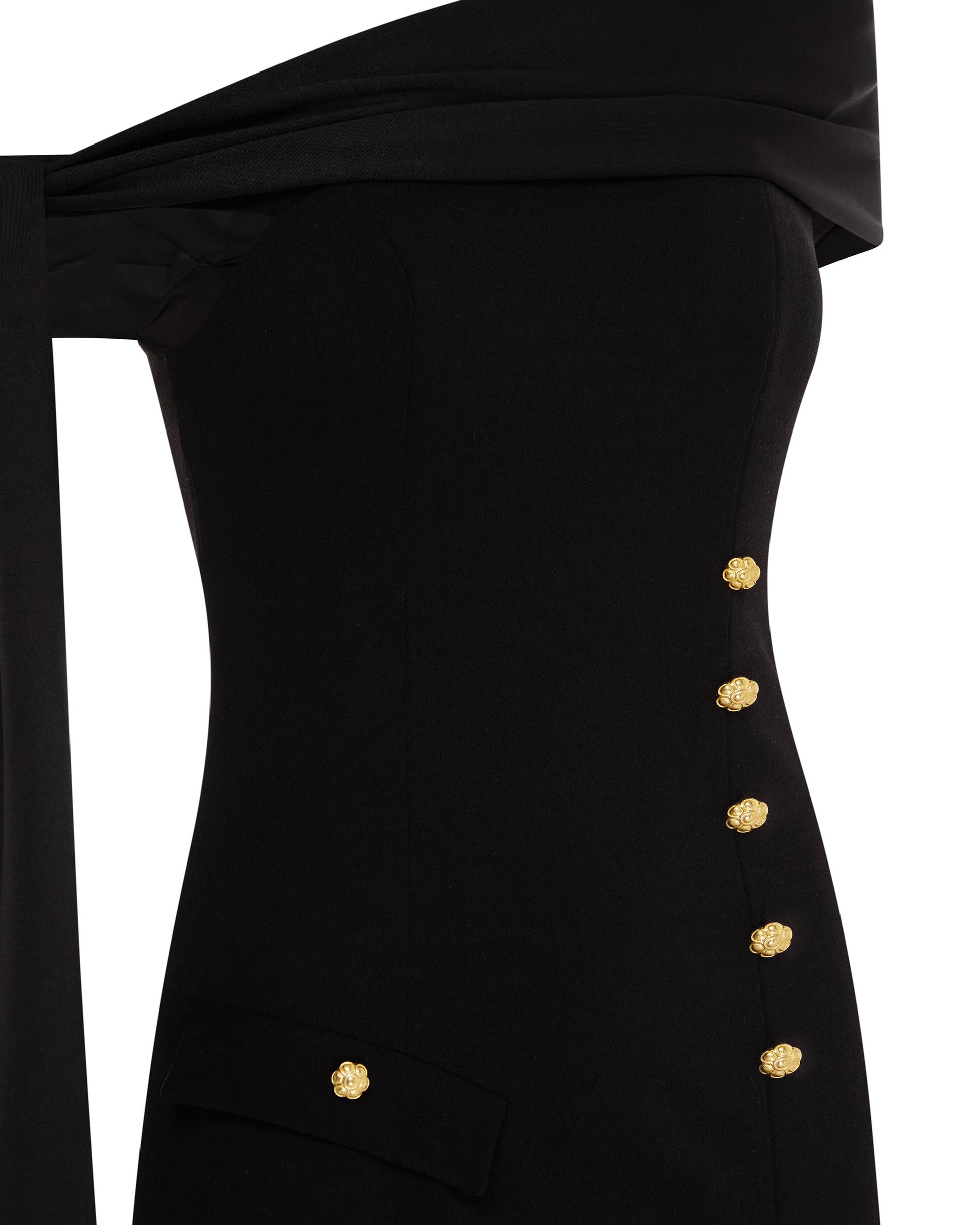 Black off-shoulder dress with gold button detailing. Close up.