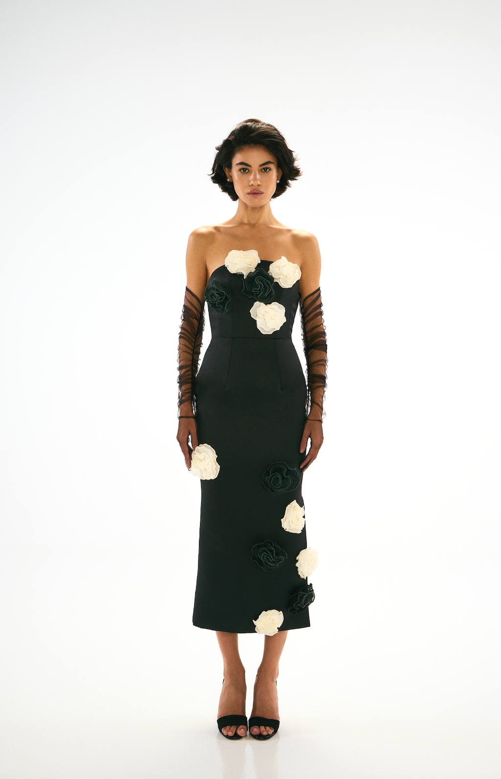Black fitted midi dress with black and white flower detailing. Long black tulle gloves, Front