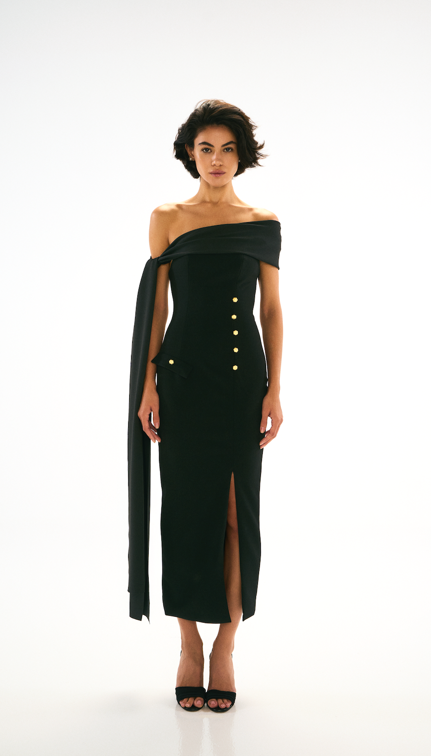 Black off-shoulder dress with gold button detailing. Front